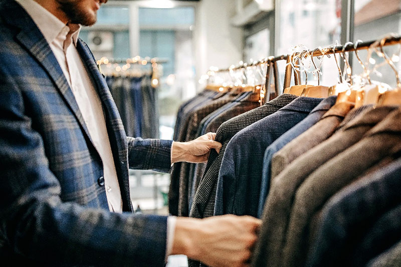 homme d'affaires essayant un costume dans un magasin