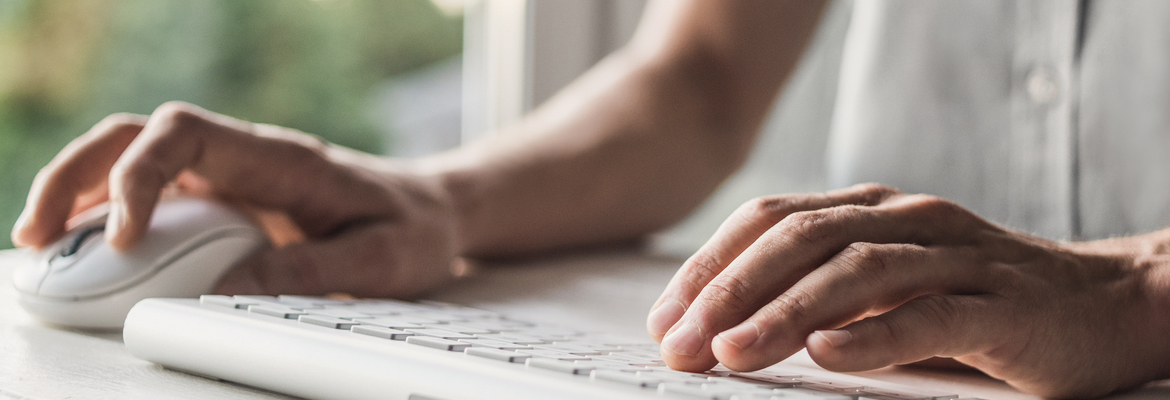 man typing on computer