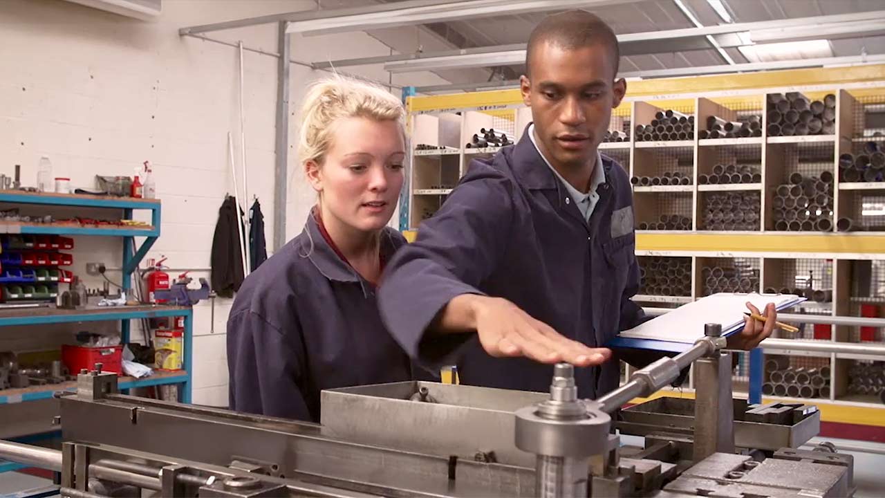 plant employees reviewing risk safety guidelines