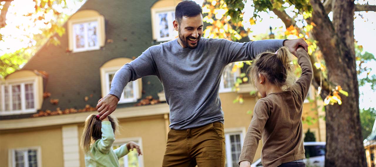 father-playing-with-daughter-at-backyard