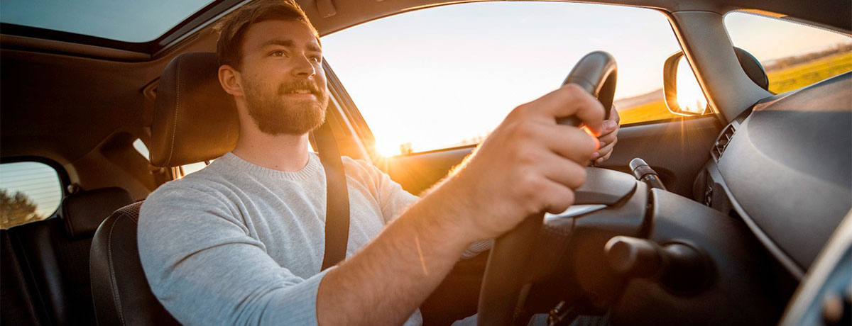 man driving luxury car