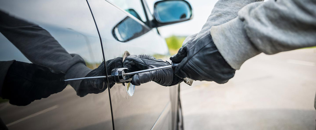 thief breaking into car door